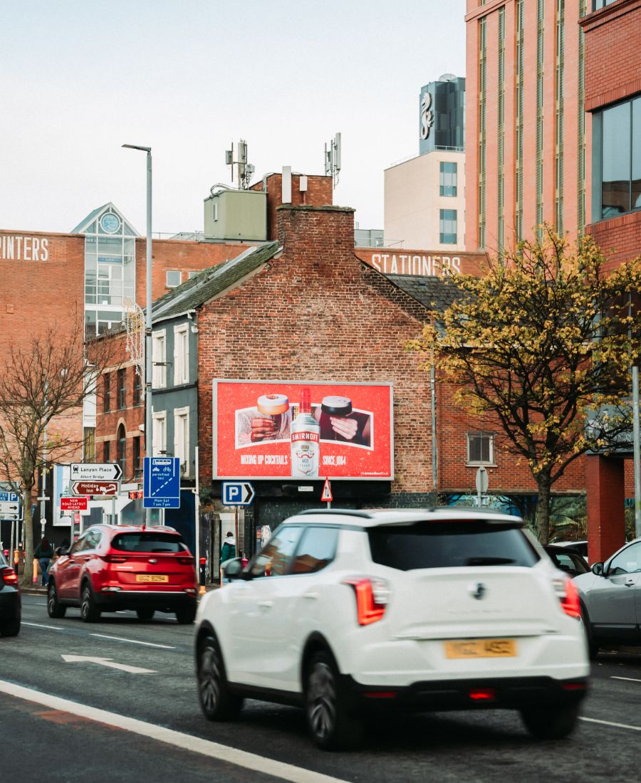 Car driving by smirnoff ice ad on great victoria street